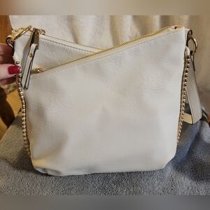 NWOT-Stylish white faux leather purse. Has gold studs along the sides and gold